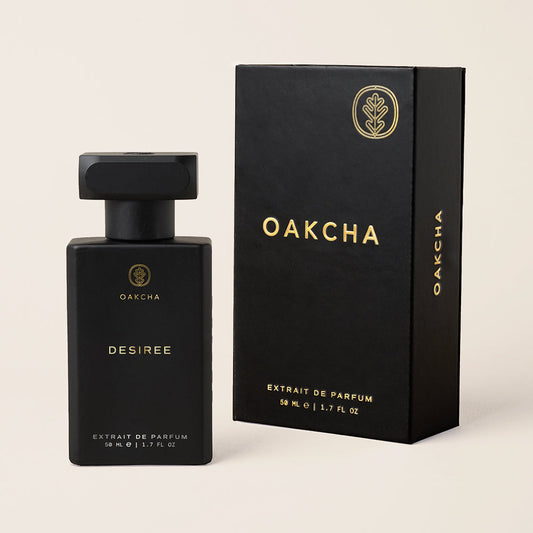 Black Oakcha perfume bottle and packaging on a beige background